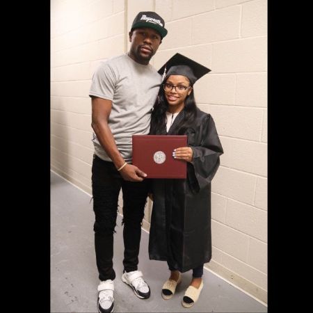 Iyanna Mayweather in her graduation gown poses a picture with Floyd Mayweather.